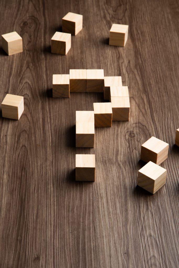 Forming bigger question mark. question mark on wooden table background